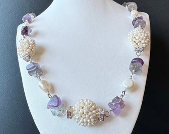 Necklace in "scaramazze" pearls and purple amethyst gems with 925 silver settings and zircons. Handmade in Italy.