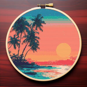 May include: A cross-stitch embroidery in a wooden hoop depicts a tropical sunset scene. The design features palm trees, a setting sun, and ocean waves in shades of teal, orange, and pink. The hoop is approximately 10 inches in diameter.