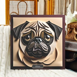 May include: A papercraft portrait of a pug dog with brown eyes and a black nose. The dog's name, "Oliver", is written in a gold frame at the bottom of the image.