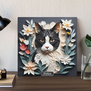 Svartvit katt bland blommande blommor - Livfull blommig och kattliknande canvastavla för heminredning i pappersklippsimitationsstil 14" x 14"