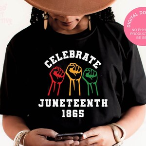 May include: Black t-shirt with white text that says "Celebrate Juneteenth 1865". Three raised fists are shown in red, yellow, and green.