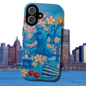 May include: A blue phone case featuring a detailed illustration. The artwork includes a blue statue, pink flowers, a bridge, a lighthouse, a boat, and the word "MOTOWN". Two red cherries are also depicted.