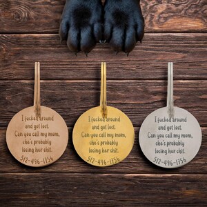 Three round engraved dog ID tags shown side by side in gold, rose gold, and silver finishes with large dog paws above. Each tag reads “I fcked around and got lost. Can you call my mom, she’s probably losing her sht.” plus phone number. Sturdy custom pet tags offer durability, style, and safety while adding humor. Perfect for playful dogs, funny gift for pet parents who want reliable identification with personality.