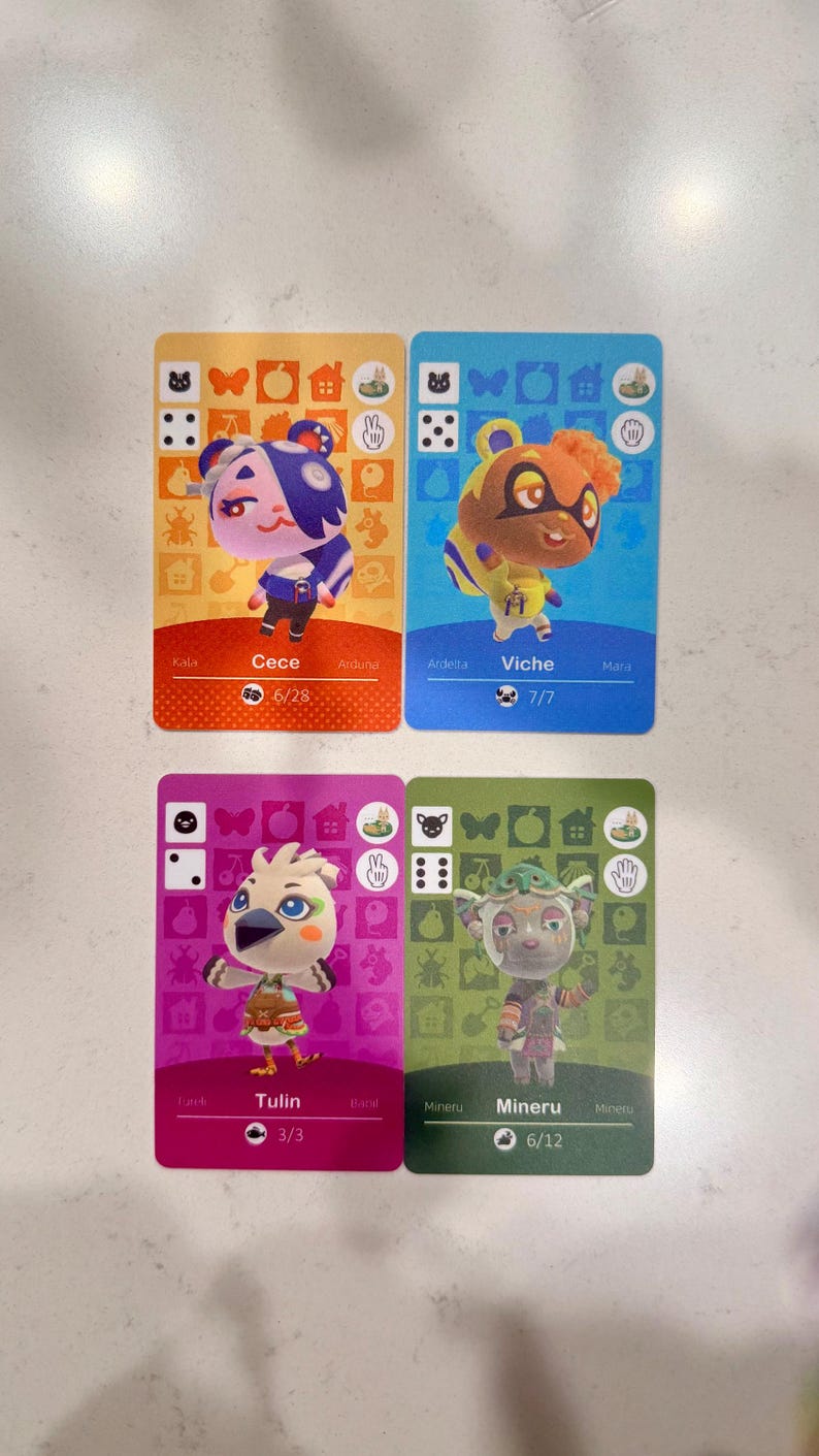 May include: Four rectangular trading cards featuring Animal Crossing characters. Top left is orange with Cece, top right is blue with Viche, bottom left is magenta with Tulin, and bottom right is green with Mineru. Each card displays icons, names, and numbers.