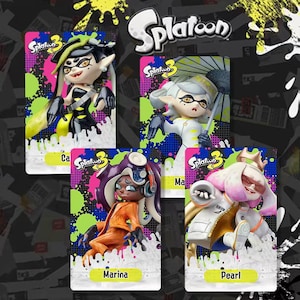 May include: Four character figures from the video game Splatoon 3 are displayed on cards. The figures are in various poses and outfits, with vibrant colors and details. The cards have the Splatoon 3 logo and character names.