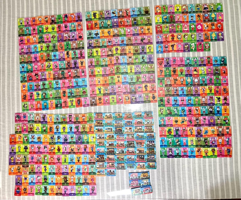 May include: A large collection of rectangular trading cards featuring colourful illustrations of various animal characters and interior scenes. The cards are arranged in multiple grid-like groups, showcasing diverse background colours and character designs.