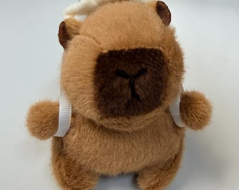 Llavero de peluche de capibara, con cola o alas giratorias, adorable accesorio para bolso.