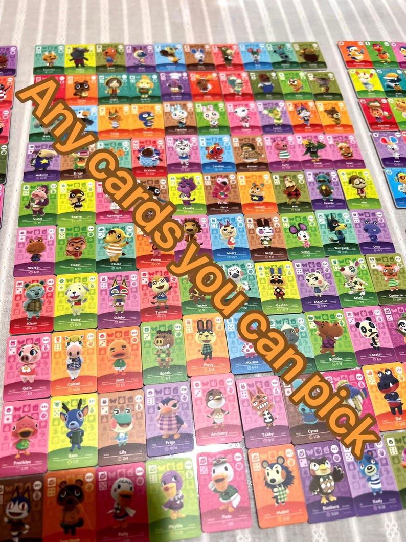 May include: A large collection of rectangular Animal Crossing trading cards arranged in a grid, each featuring a unique character illustration, a coloured background, and game-related icons. The text Any cards you can pick is overlaid.