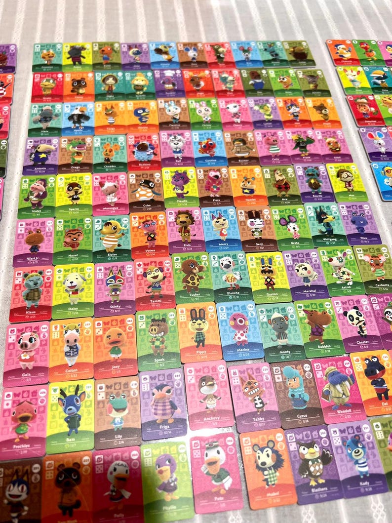 May include: A large collection of rectangular Animal Crossing trading cards arranged in a grid. Each card features a unique illustrated character, a coloured background, and various game-related icons including numbers and symbols.