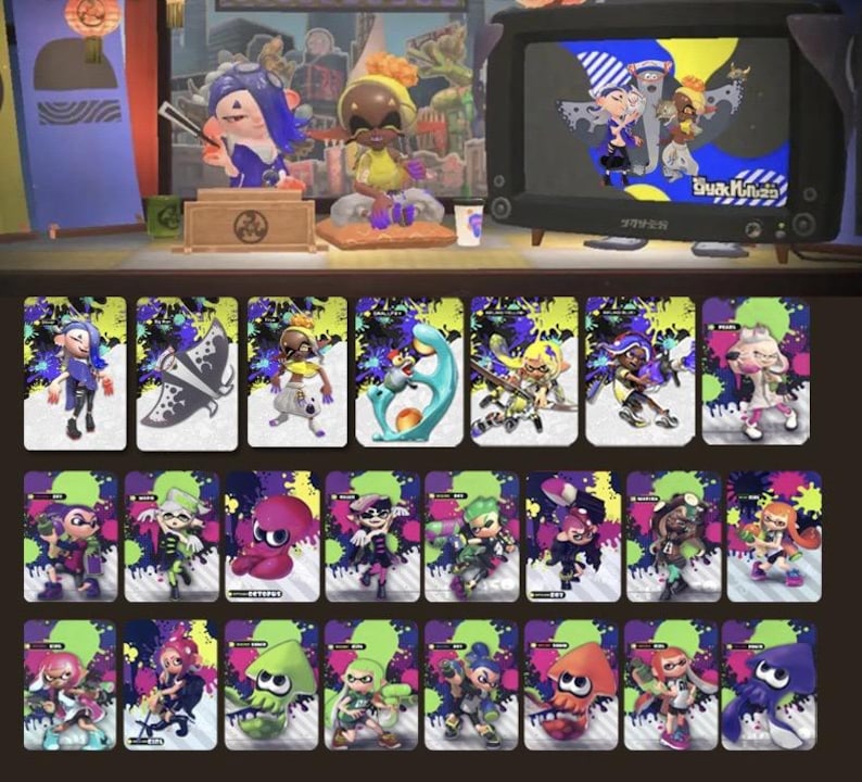 May include: A collection of colorful trading cards featuring characters from a video game. The cards have a vibrant design with ink splatters and character illustrations. The image also includes figurines and a retro television displaying game characters.