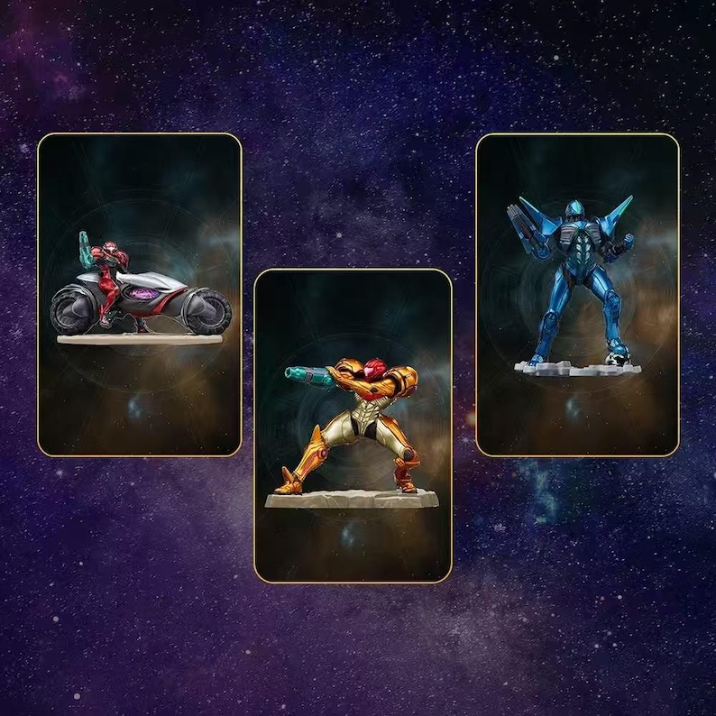 May include: Three action figures of characters from a science fiction video game. One figure is riding a futuristic vehicle, another is in a combat pose, and the third is a blue robotic figure. The figures are set against a starry background.