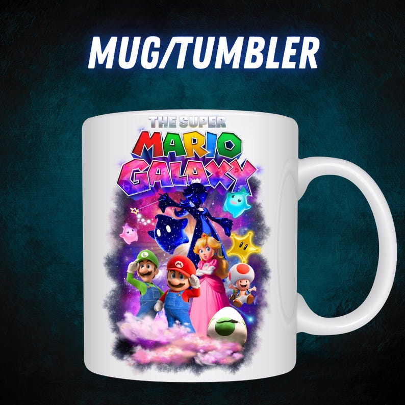 May include: White ceramic mug with a colourful graphic from "The Super Mario Galaxy" video game. The design includes Mario, Luigi, Princess Peach, and other characters. The mug has a curved handle and the text "MUG/TUMBLER" at the top.