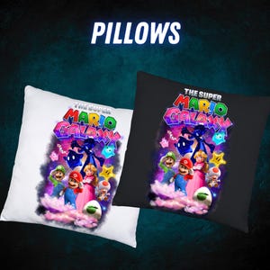 May include: Two square pillows, one white and one black, with a colourful graphic from "The Super Mario Galaxy." The pillows show Mario, Luigi, Princess Peach, and other characters. The word "PILLOWS" is at the top.
