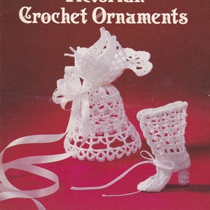 May include: A book cover featuring a white crocheted bell and boot with a white ribbon. The book title is "Victorian Crochet Ornaments" and the text below reads "22 Easy Decorations for Christmas, Weddings & Special Occasions".