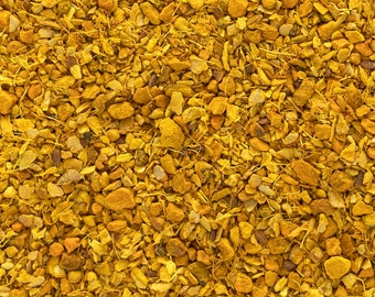 May include: Close-up of a pile of dried turmeric root pieces. The pieces are a vibrant yellow-orange color and have a rough, fibrous texture.