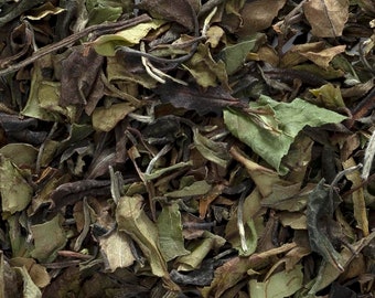 May include: Loose leaf white tea with a mix of light green and brown leaves.
