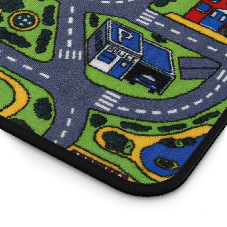 Mousepad with a colorful 90s/2000s-style city street carpet design, featuring winding roads, buildings, and trees on a blank white background.