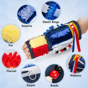 May include: A blue sensory wrist cuff with various textures, including sequins, fur, flannel, beads, elastic rings, a zipper, and ribbons.