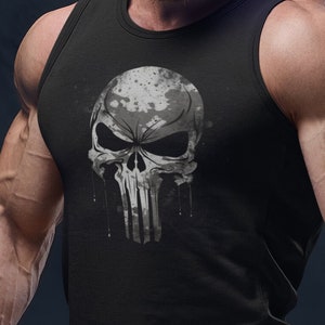 Pode incluir: Uma camiseta preta sem mangas com um gráfico de caveira branca. A caveira tem um padrão de camuflagem e pinga tinta branca.