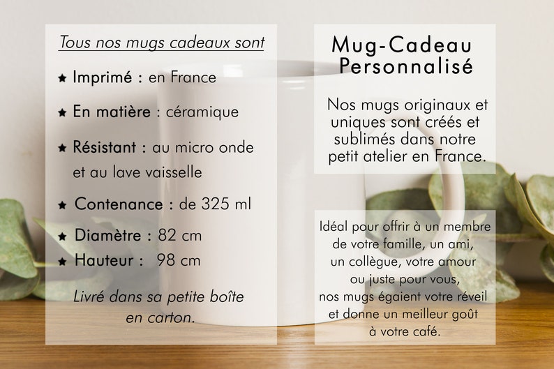 May include: White ceramic mug with black text that reads "Mug-Cadeau Personnalis&eacute;". The mug is 8.2 cm in diameter and 9.8 cm tall. It holds 325 ml. The mug is sitting on a wooden surface with green leaves.