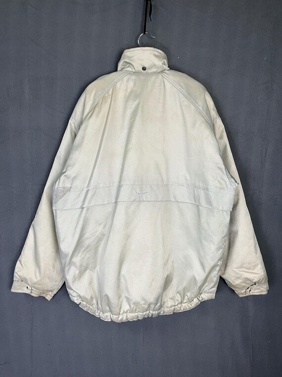 white and silver nike windbreaker