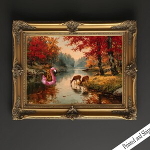 May include: A framed landscape painting in a gold ornate frame. The artwork shows a river scene with deer drinking water, a pink flamingo float, and autumn foliage. The words "Printed and Shipped" are visible.