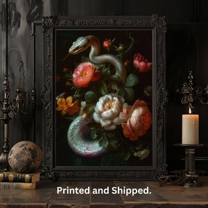 May include: A framed print of a still life featuring a white snake coiled around a bouquet of colorful flowers. The flowers include pink, red, white, and yellow blooms. The background is dark and the frame is black.