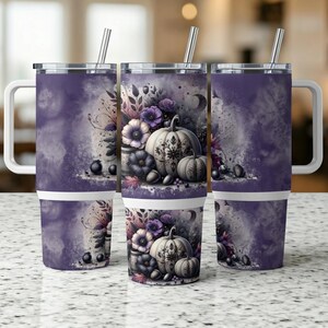 May include: Three purple and white travel mugs with handles and silver straws. Each mug features a watercolor design of pumpkins, flowers, and berries. The design is set against a purple and white background.
