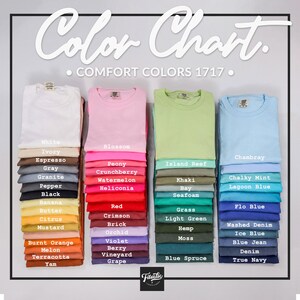 May include: A color chart displays a variety of Comfort Colors 1717 t-shirts in various shades. The chart includes colors like white, pink, green, and blue, with names such as "Blossom," "Island Reef," and "Chambray." The image also features the brand logo.
