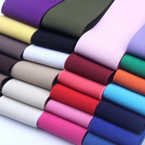 May include: A variety of colors of elastic trim, including purple, green, yellow, brown, white, beige, red, pink, orange, blue, and light purple.