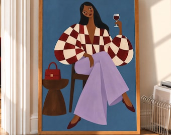May include: A framed wall art print featuring an illustration of a person with long dark hair wearing a red and white checkered blouse and light purple wide-leg trousers, sitting on a chair while holding a glass of red wine.