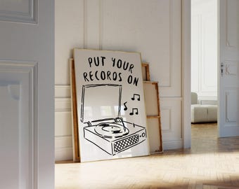 Könnte beinhalten: Ein weißer gerahmter Druck mit einer Schwarzweißillustration eines Plattenspielers mit dem Text "PUT YOUR RECORDS ON" und Noten.