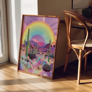 May include: A framed print of a desert landscape with a rainbow arching over a field of cacti. The print has a vibrant color palette with pink, purple, and green hues.