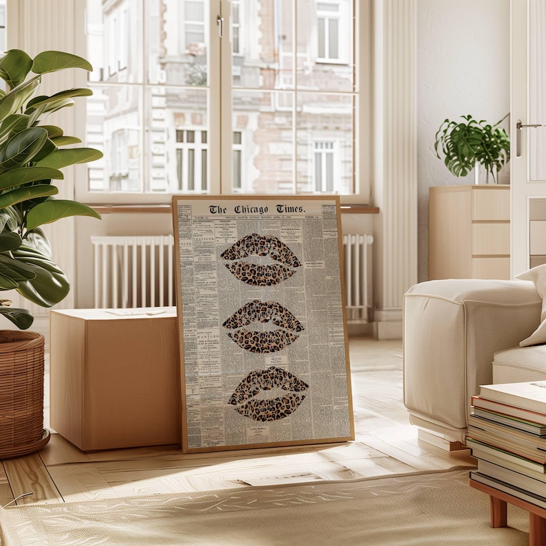 May include: A framed print displaying three leopard print lips against a backdrop of a vintage newspaper. The newspaper is titled "The Chicago Times." The print is in a room with neutral tones and natural light.