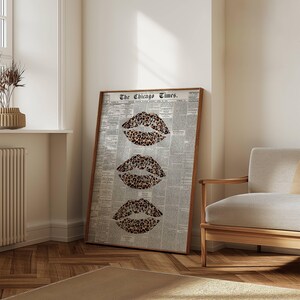 May include: A framed art print displaying three leopard print lips against a backdrop of a vintage newspaper. The print, titled "The Chicago Times", is presented in a wooden frame. The artwork is leaning against a wall.