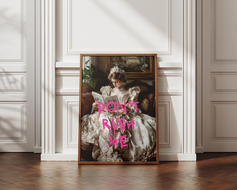 May include: A framed print of a woman in a white dress sitting on a couch and reading a book. The text "DON'T RUSH ME" is written in pink across the image.
