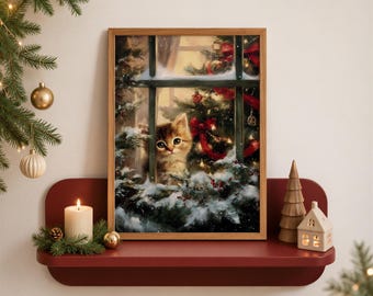 May include: A framed rectangular wall art print featuring a brown tabby kitten looking through a window at a snow-covered Christmas tree decorated with red ribbons and lights. The artwork is displayed on a dark red shelf with a white candle.