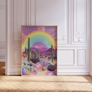 May include: A digital art print featuring a rainbow arching over a desert landscape with cacti and colorful rocks. The background is a vibrant purple and pink gradient.