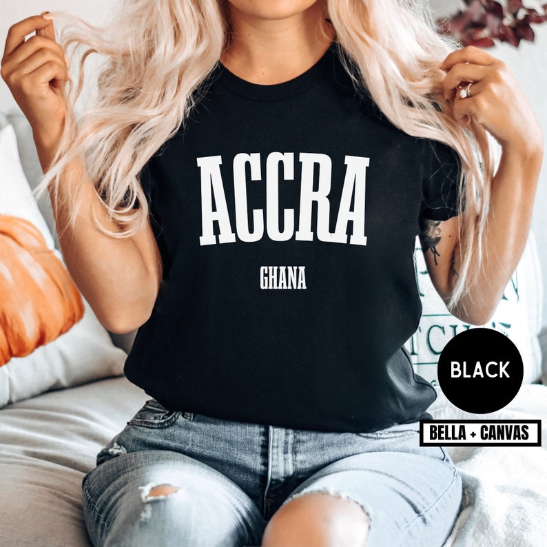 May include: Black t-shirt with white text that reads "ACCRA GHANA".