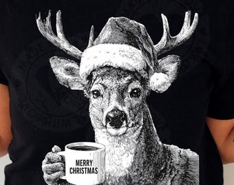 May include: Black t-shirt featuring a black and white illustration of a deer wearing a Santa hat and holding a mug. The mug has the text "MERRY CHRISTMAS" printed on it. The shirt is a crew neck.