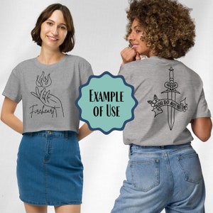 May include: Two gray cropped t-shirts with different graphic designs. The front of one shirt features a hand holding a flame with the text "Fireheart". The back of the other shirt features a dagger with the text "You do not yield".