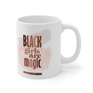 May include: White ceramic mug with the text "BLACK girls are magic" in brown and black lettering. The text is surrounded by a pink and brown watercolor design and two stylized hands. The bottom of the mug reads "beauty in every shade".