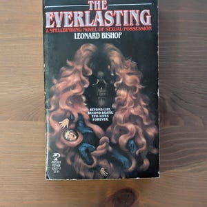May include: A vintage paperback book titled "The Everlasting" by Leonard Bishop. The cover features a skull with flowing red hair, a figure in blue, and the text "Beyond Life. Beyond Death. Evil Lives Forever."
