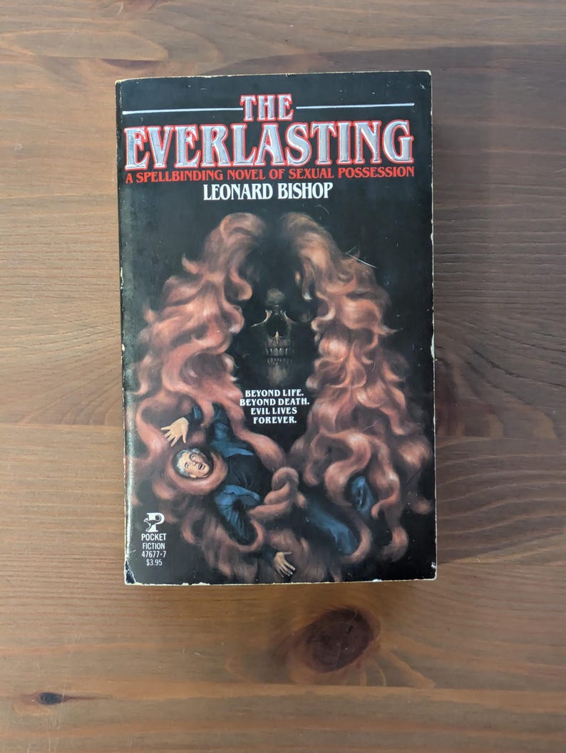May include: A vintage paperback book titled "The Everlasting" by Leonard Bishop. The cover features a skull with flowing red hair, a figure in blue, and the text "Beyond Life. Beyond Death. Evil Lives Forever."