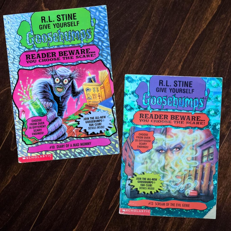 May include: Two R.L. Stine Give Yourself Goosebumps books. The left book is #10 Diary of a Mad Mummy with a mummy illustration. The right book is #13 Scream of the Evil Genie featuring a green smoke illustration. Both have Scholastic logos.