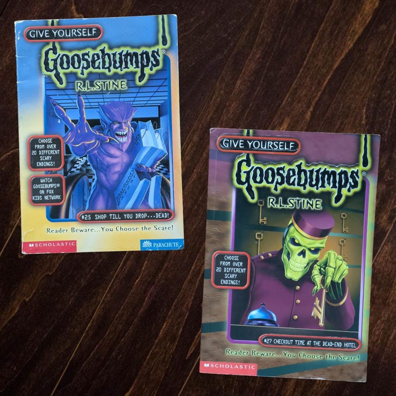 May include: Two Give Yourself Goosebumps books by R.L. Stine. The left book is #25 Shop Till You Drop...Dead! featuring a purple monster. The right book is #27 Checkout Time at the Dead-End Hotel featuring a green skeleton bellhop in a purple uniform.