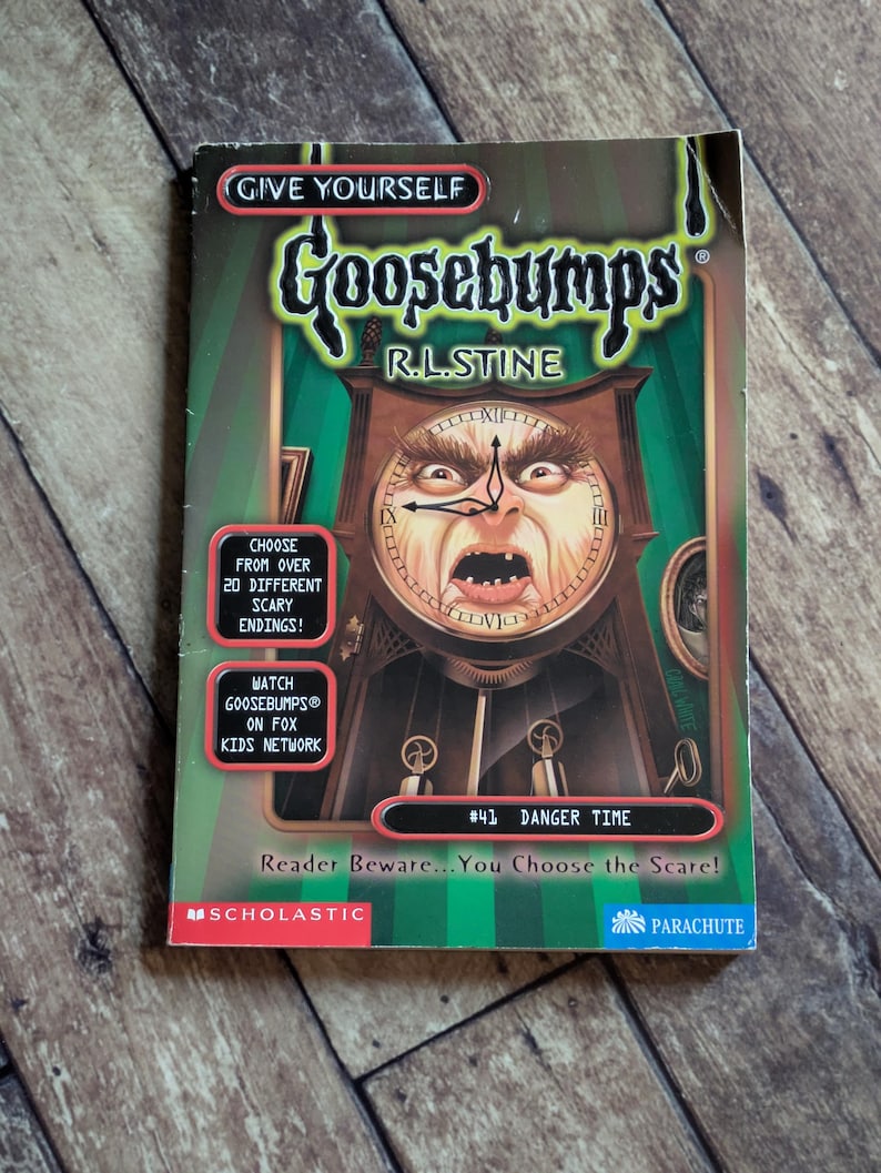 May include: A Give Yourself Goosebumps book titled Danger Time by R.L. Stine. The cover features a grandfather clock with a human face, green striped background, and text boxes stating Choose from over 20 different scary endings and more.
