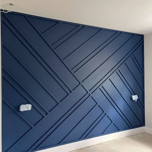 May include: A wall with a geometric pattern made of dark blue wood panels. The panels are arranged in a criss-cross pattern, creating a modern and stylish look.