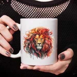 May include: White ceramic mug with a colorful watercolor illustration of a lion's head. The lion has a red mane and a fierce expression.