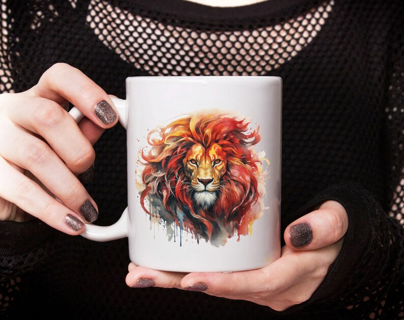 May include: White ceramic mug with a colorful watercolor illustration of a lion's head. The lion has a red mane and a fierce expression.